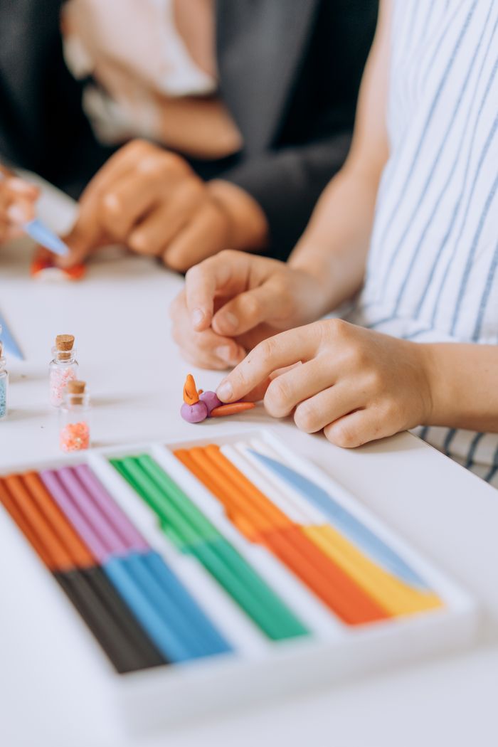 About Close-up of hands crafting with colorful clay, perfect for art and leisure themes.